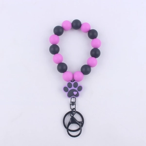 Detail of purple and black silicone beads wristlet with cute cartoon paw charm and D-ring