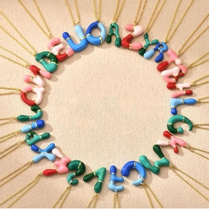 Colorful bubble initial necklaces in gold stainless steel featuring A-Z enamel pendants