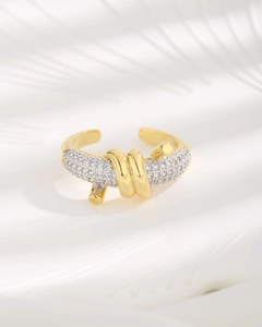 Detailed macro view of the gold multi-layer wrap ring with paved white zircons