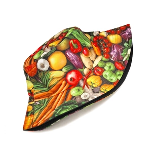 Detailed close-up of reversible bucket hat with realistic vegetable print on white background