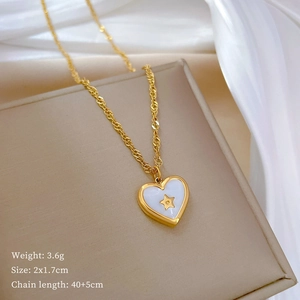 Macro shot of gold heart necklace with star pattern, 3.6g weight and size details shown