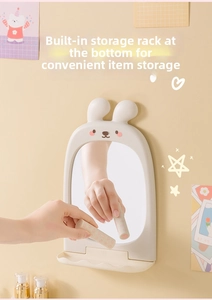 Detail of cute bunny vanity mirror showing the foldable storage rack for small cosmetics