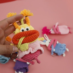 Handmade crochet monster key cover with big lips and colorful knitted yarn design