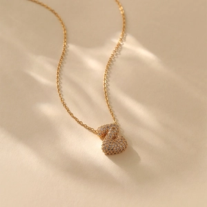 Detail of gold-plated letter Z pendant with micro-pave cubic zirconia on necklace