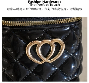 Detail of black quilted silicone bag with golden heart hardware and zipper close-up