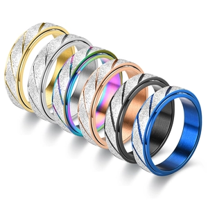 Six frosted stainless steel spinning rings in gold, silver, black, and multi-color tones