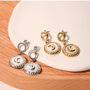 Detailed shot of round lunar mother of pearl earrings in gold and silver finish
