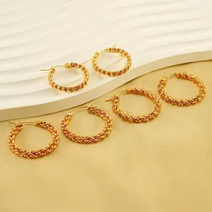 Three pairs of elegant twisted golden titanium steel hoop earrings in various sizes