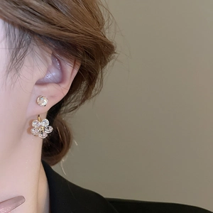 Elegant gold flower earrings with crystals, two-way wear style shown on female model