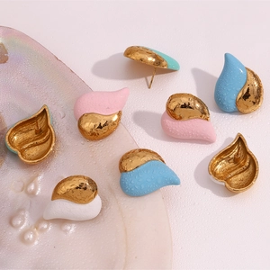 Macro shot of 18K gold-plated heart earrings with pink enamel and water drop texture