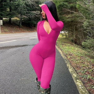 Detail of hot pink ribbed fabric on a long sleeve V-neck slimming jumpsuit