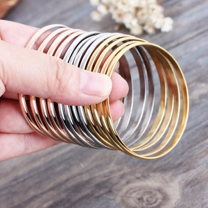 Polished stainless steel thin bangle set in gold, rose gold, and silver finishes