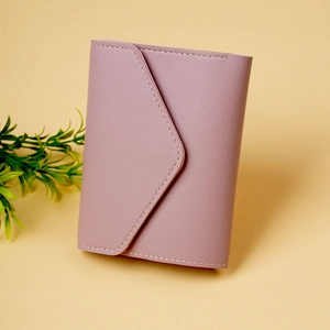 Detail of dusty rose pink envelope wallet with litchi texture and white stitching