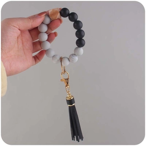 Beaded silicone keychain bracelet with black tassel and marble patterns for women