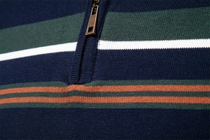 Detail of navy stripe sweater with metal half-zip and fine knit texture close-up