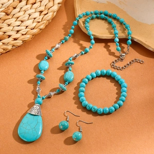 Detail of bohemian turquoise jewelry set with layered necklace, bracelet and earrings