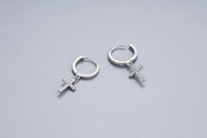 Macro shot of S925 sterling silver cross earrings with sparkling zircon inlay details