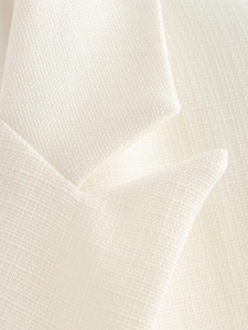Detail of the white suit collar showing the premium textured fabric and fine stitching