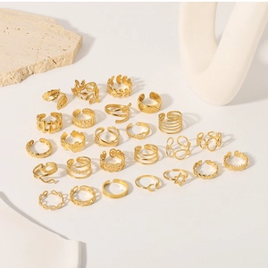 Flat lay of diverse 18k gold plated stainless steel rings with leaf and snake designs