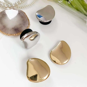 Close-up of gold and silver irregular mirror-finish phone grips with expandable base