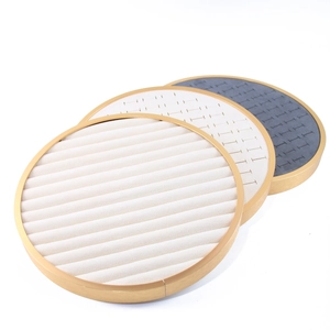 Set of round jewelry display trays in beige, white and grey with elegant gold metal frames