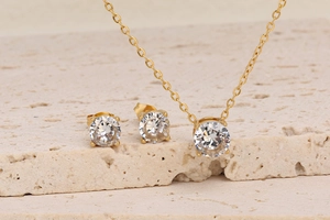 Close-up of 18K gold-plated stainless steel necklace and stud earrings with zircon
