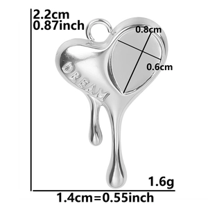 Macro detail of silver steel heart pendant with DREAM engraving and size dimensions
