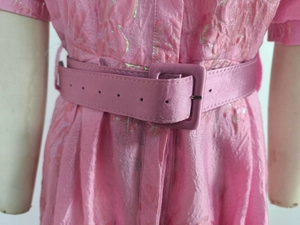 Close-up of pink jacquard dress waist with matching fabric-covered square belt buckle