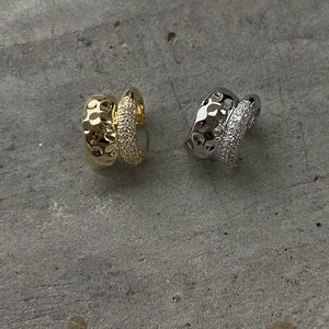Double-layered metallic ear cuffs with hammered texture and pave-set cubic zirconia accents