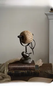 Macro detail of vintage cast iron twine holder with bird ornament and retro scissors