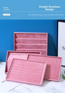 Pink velvet jewelry display trays with multiple compartments for rings and necklaces