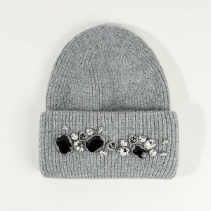 Detail of grey knitted angora beanie featuring sparkling rhinestone embellishments
