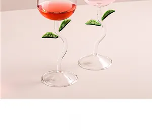 Macro shot of rose flower wine glass with creative green stem and delicate leaf details