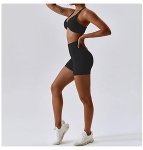 Side view of black cross-knot sports bra and high-waist shorts set in premium elastic fabric