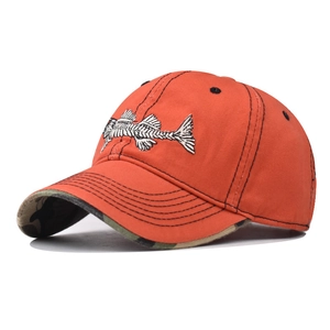 Detail of orange baseball cap with fish bone embroidery and camouflage brim underside