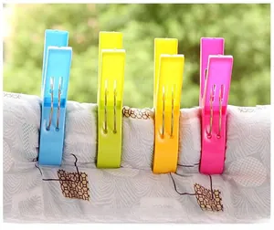 Close-up of colorful plastic clothes pegs with strong metal springs and anti-slip teeth
