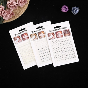 Three packs of white pearls and crystal diamond face stickers with floral decorations
