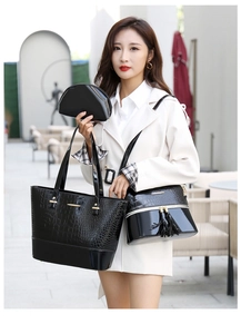 Three-piece black crocodile embossed handbag set with elegant gold hardware details