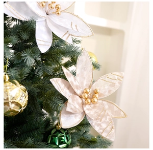 Close-up of 25cm cream Christmas flower with gold bead center on a decorated tree
