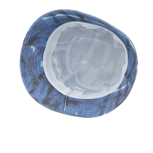 Blue and white tie-dye bucket hat with wide brim showing interior stitching and wash label