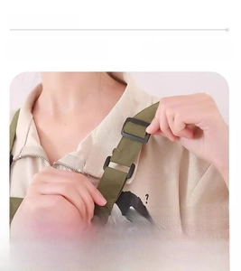 Detail of adjustable apron strap with black plastic buckle for custom fit on workwear