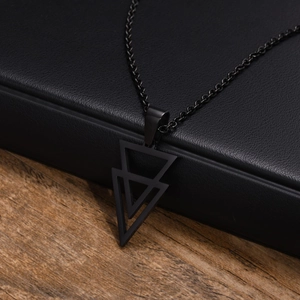Close-up of a men's black geometric double triangle pendant necklace on leather