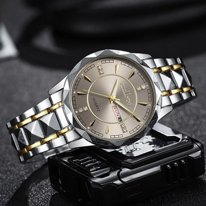 Detail of waterproof watch with gold-silver strap and champagne diamond dial