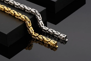 Détail de bracelets byzantins de 8mm en or et argent sur un coffret cadeau noir chic