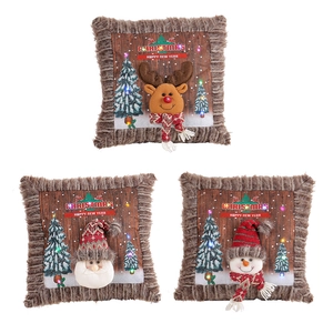 Three Christmas throw pillows with plush trim featuring Santa, reindeer and snowman designs