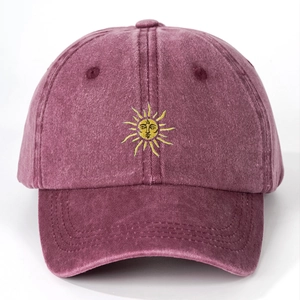 Detailed view of sun embroidery and textured washed purple canvas baseball cap