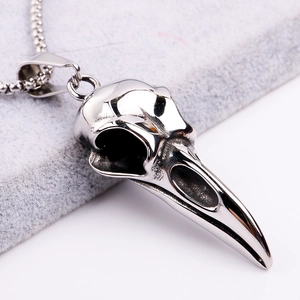 Detailed macro shot of gothic eagle skull pendant in polished stainless steel finish