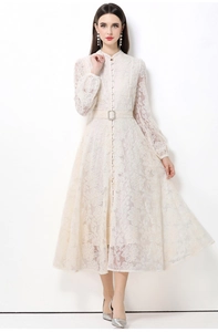 Détail de dentelle florale avec boutons et ceinture assortie sur cette robe élégante