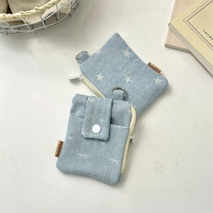 Set of two light blue denim card pouches with star pattern, bow texture and metal hooks