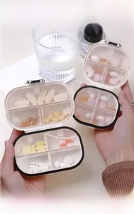 Detail of a portable 7-compartment pill box showing separate sections for tablets and capsules